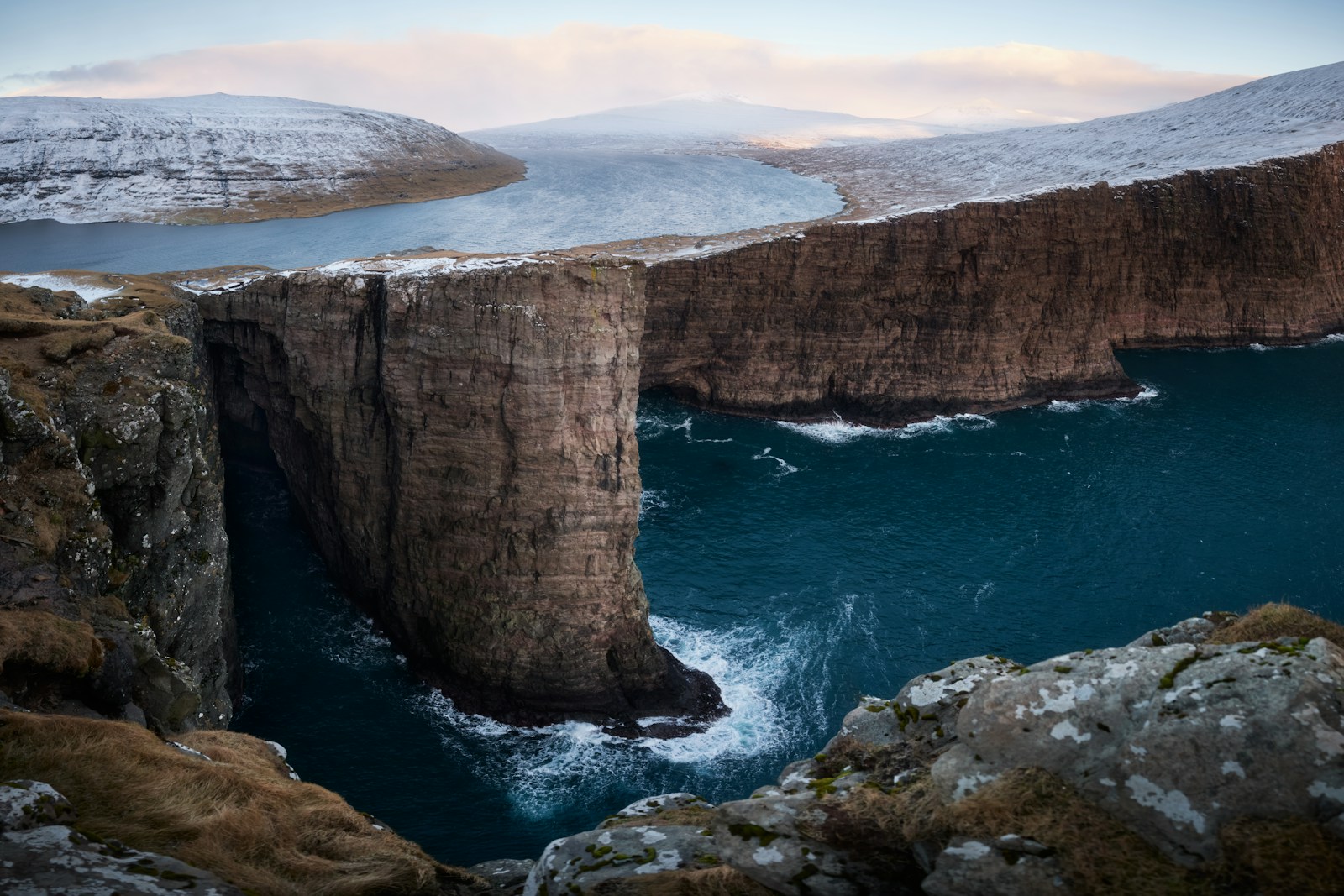A large body of water surrounded by rocky cliffs