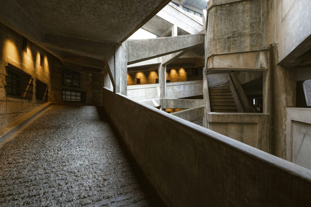 Concrete architecture features a winding ramp and stairs.